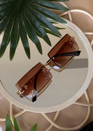 Rimless rectangle sunglasses in the shade brown.